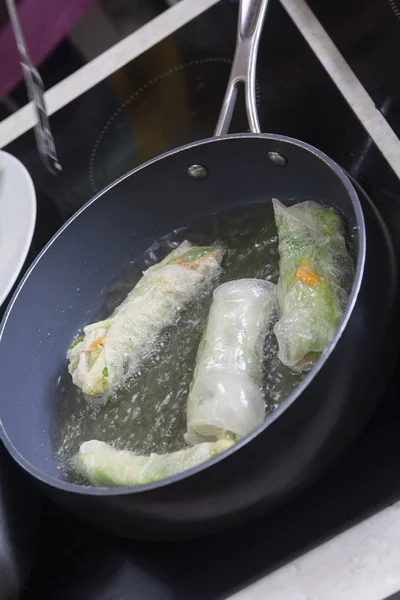 Chef giving cooking classes in kitchen Fried spring rolls tasty healthy dishes with vegetables Vietnamese cuisine