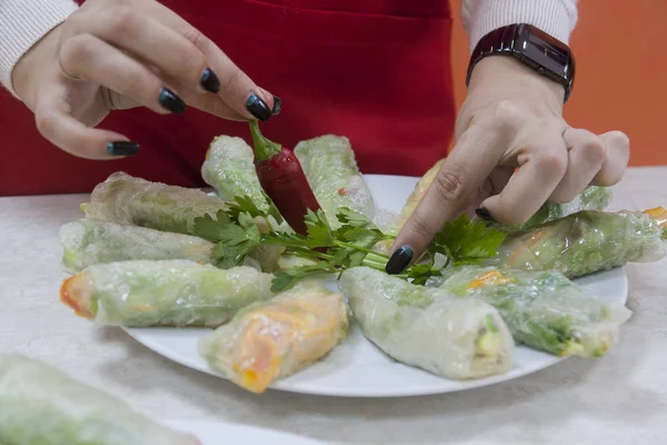Chef giving cooking classes in kitchen Fried spring rolls tasty healthy dishes with vegetables Vietnamese cuisine