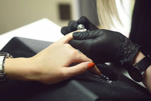 Shellac removal. The master makes a manicure. Relaxing day at beauty salon. Manicurist master makes manicure on woman\'s hand. Girl nails, color gel nail Polish finger in nail salon training.