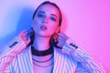 Bir ceket genç zarif kız moda portresi. Renkli neon