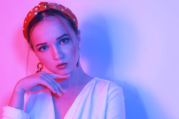 Fashion portrait of young elegant girl in a white dress. Sensual