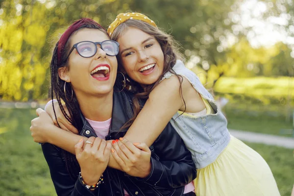 Zwei Freundinnen gehen im Park spazieren. Schwestern haben Spaß bei s — Stockfoto