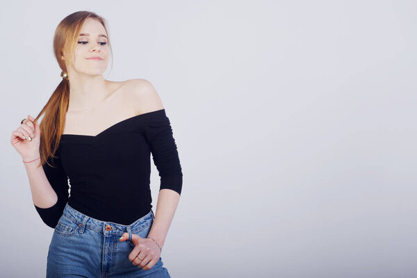 Beautiful blonde student girl posing on white background