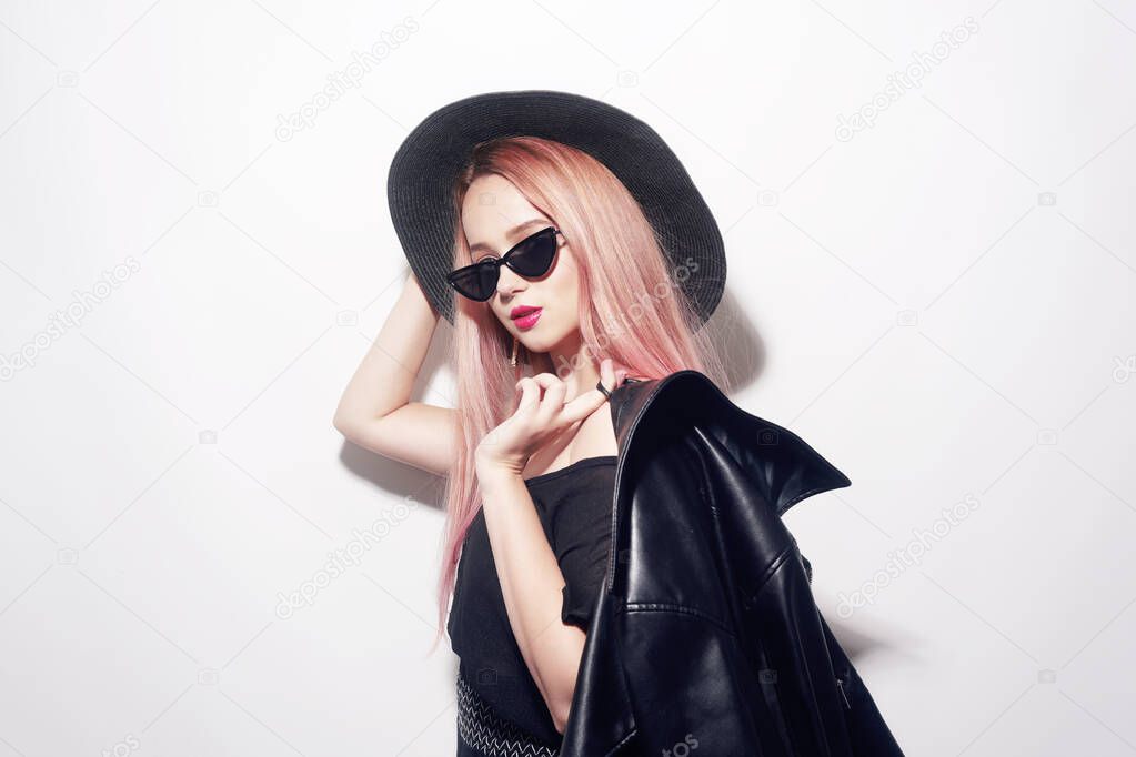 Girl with pink hair in glasses and a hat in black clothes. Black Friday. 