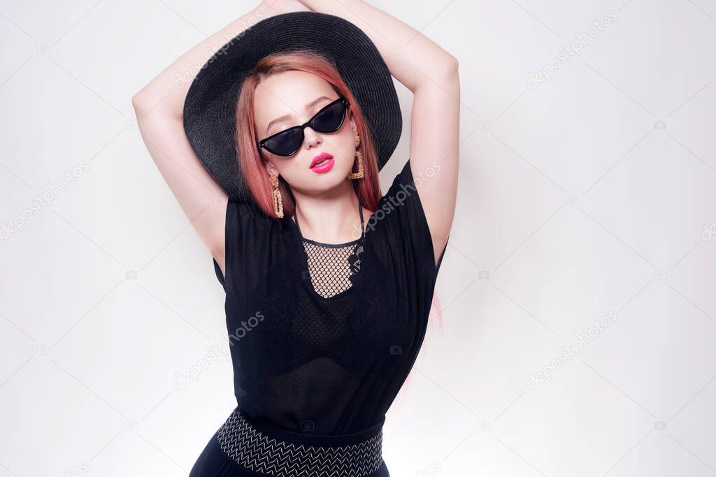 Girl with pink hair in glasses and a hat in black clothes. Black Friday