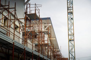 detail of a residential construction site with tower crane on the right. clipart