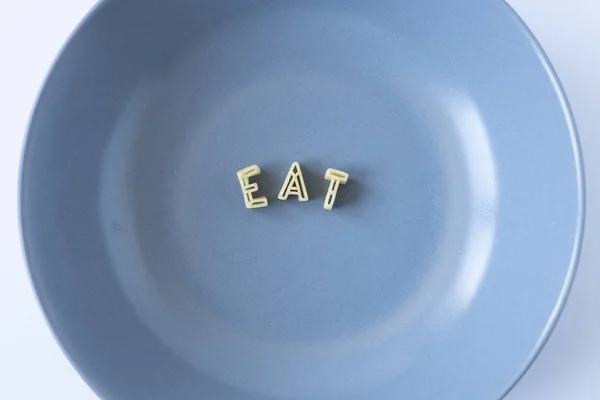 Word Eat Composed Real Pasta Letters Blue Dish — Stock Photo, Image