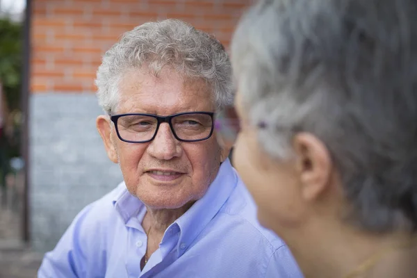 Older man smiling at his wife