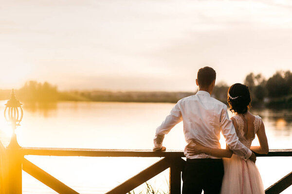  young couple of newlyweds by lake 