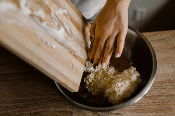 Woman Adding Grated White Butter Cheese Cake Wooden Table — Stock Photo, Image