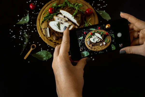 stock image person taking picture of fresh grilled meat. 