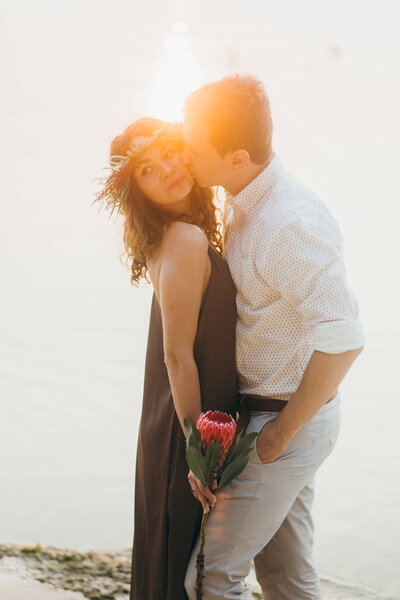 Happy beautiful young  couple kissing outdoors