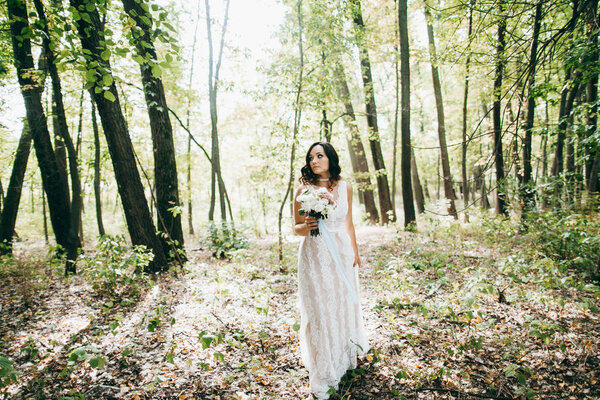 Delicate beautiful bride in the forest