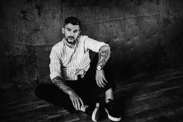 stüdyoda oturan genç yakışıklı adam