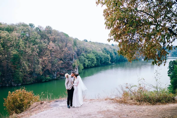 湖でポーズ新婚の若いカップル — ストック写真