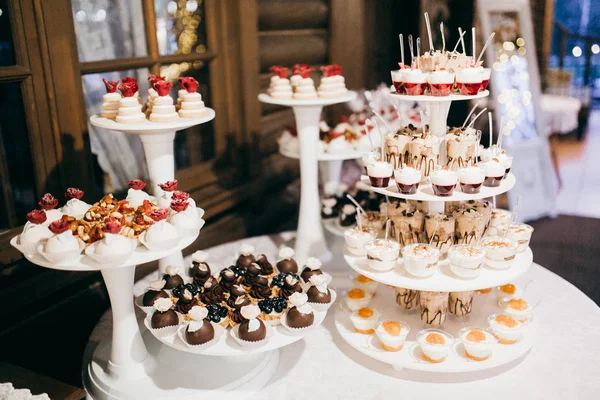 Candy bar with different sweets on the wedding