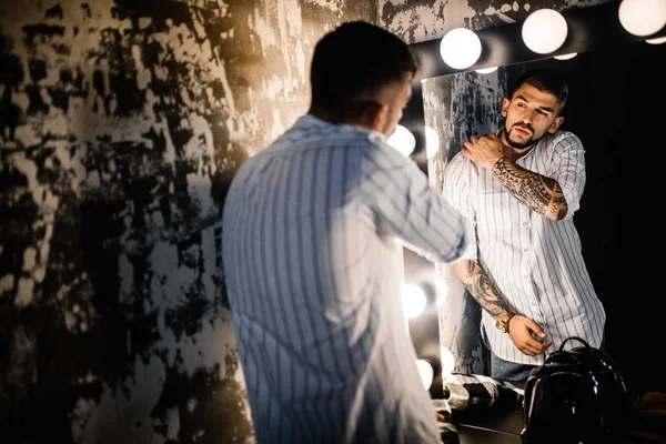 young handsome  man looking in mirror