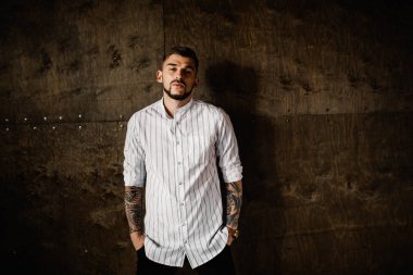 Stüdyoda poz veren genç yakışıklı adam.