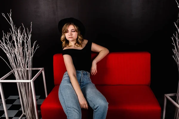 young  beautiful woman posing sitting on sofa