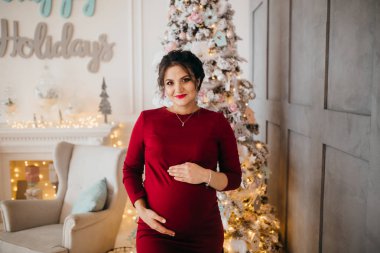 mutlu güzel hamile kadın Noel ağacı tarafından poz