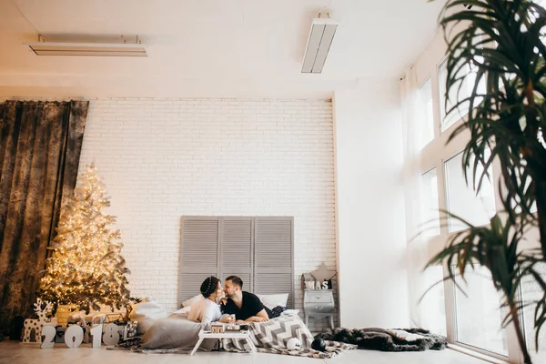 Happy  married couple in living room  on   Christmas