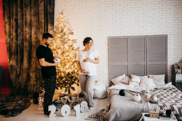 Noel'de poz mutlu evli çift. adam holding oyuncak