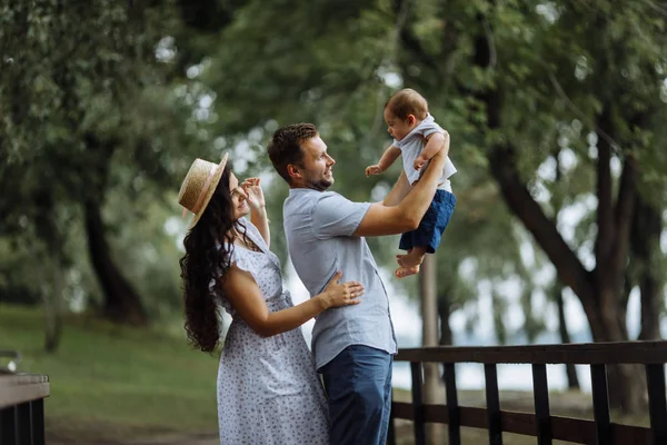 Parkta küçük bir oğlu olan mutlu genç bir aile.