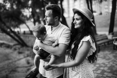 Parkta küçük bir oğlu olan mutlu genç bir aile.