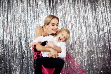 Mutlu genç anne ve oğlu alışveriş arabasında eğleniyorlar. 