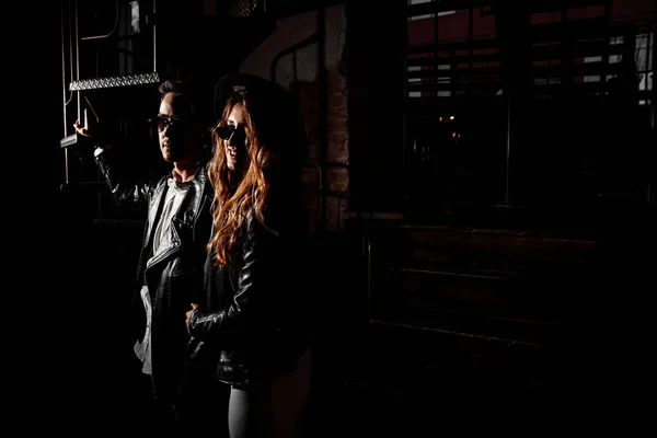 Beautiful young couple  posing in darkness