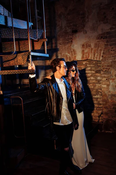 Beautiful young couple  posing in darkness