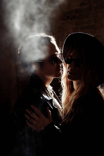Beautiful young couple  posing in darkness