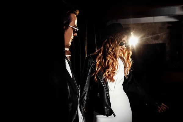 Beautiful young couple  posing in darkness