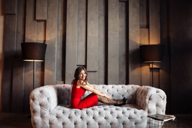 Kanepede poz veren güzel genç bir kadın. 