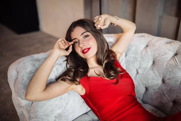 Kanepede poz veren güzel genç bir kadın. 