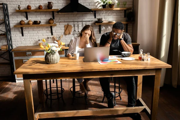 Young couple  of designers  with laptop on kitchen
