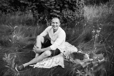 Genç adam bahçede piknik yapıyor.. 