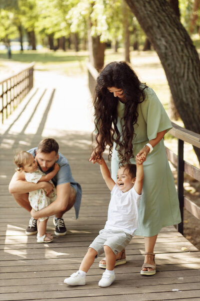 Happy young family with children relaxing  in the park