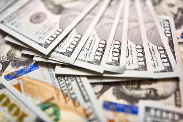 Macro shot of a new 100 dollar bill. Background of 100 dollar bills