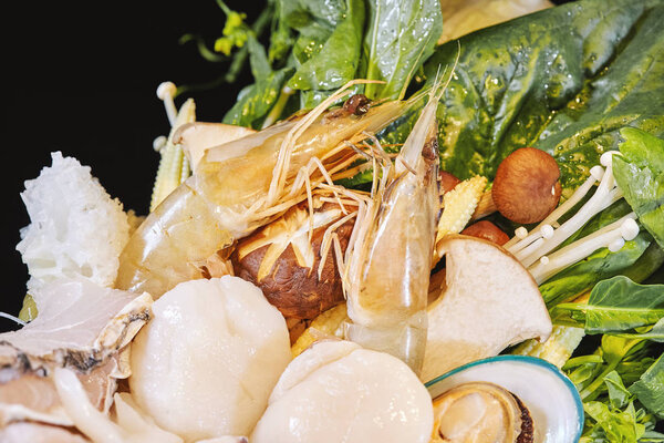 Close-up, Selective focus on the prawns and shellfishes of the mixed set of seafood in the big bowl with shallow depth of field