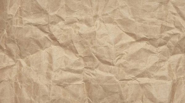 Abstract crinkle crumpled kraft paper background, brown paper rumple with textured