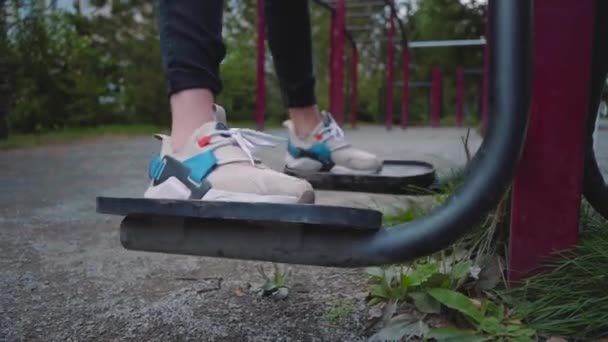 筋肉を強化するために路上で運動マシン 庭のスポーツグラウンド 女性の足をクローズアップ 家の近くで無料でエクササイズ — ストック動画