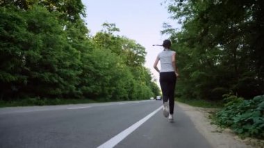 kırsal kesimde açık yol üzerinde çalışan kadın atlet