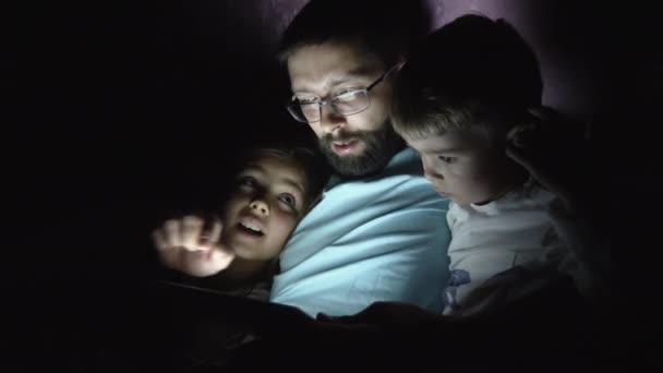Отец с детьми использовать цифровой планшет ночью — стоковое видео