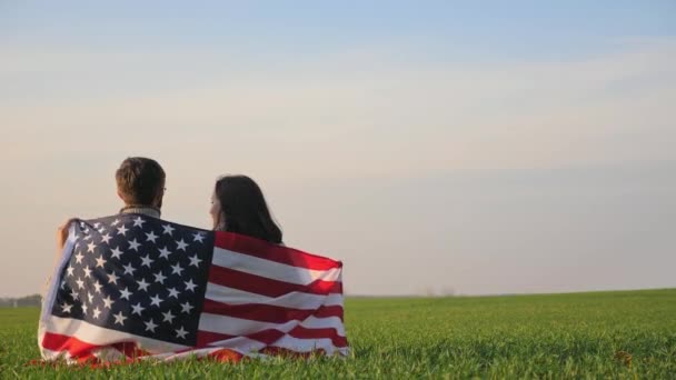 Man en vrouw gewikkeld door de vlag van Amerika — Stockvideo
