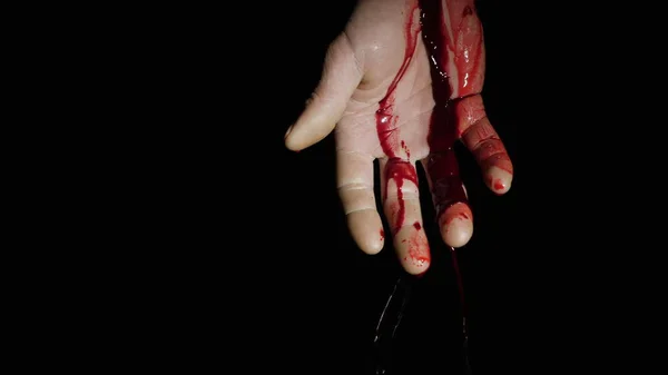 On the human hand, natural blood flows down against a dark background — Stock Photo, Image