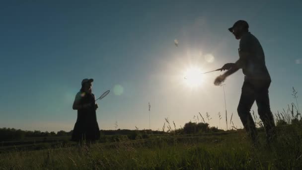 Familia jugando al bádminton en el fondo del atardecer — Vídeos de Stock