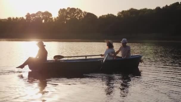 Familia flotando en un barco con remos — Vídeo de stock