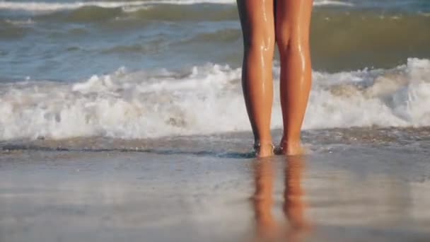 Menina pés lavados por ondas do mar, close-up — Vídeo de Stock