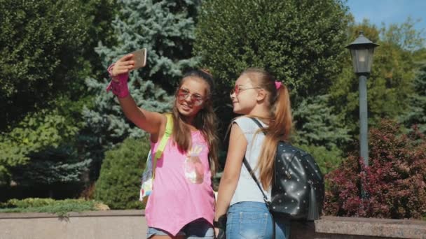 Schoolgirls görkorcsolya hogy egy selfie a smartphone — Stock videók